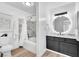 Modern bathroom with a stylish vanity, a circular mirror, and a shower-tub combination at 3151 Soaring Gulls Dr # 2136, Las Vegas, NV 89128