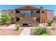 Exterior view of a two-story condominium complex with desert landscaping and a symmetrical design under a bright blue sky at 3151 Soaring Gulls Dr # 2136, Las Vegas, NV 89128