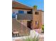 A two-story condo complex exterior view with a private balcony, plants and a walkway at 3151 Soaring Gulls Dr # 2136, Las Vegas, NV 89128