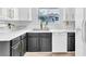 Charming kitchen features white countertops, black and white cabinetry, and modern fixtures at 3151 Soaring Gulls Dr # 2136, Las Vegas, NV 89128