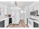 Modern kitchen featuring white appliances, black and white cabinets, and sleek countertops at 3151 Soaring Gulls Dr # 2136, Las Vegas, NV 89128