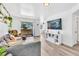 Bright living room featuring modern decor, laminate flooring, and a sliding glass door to the balcony at 3151 Soaring Gulls Dr # 2136, Las Vegas, NV 89128