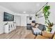 Bright living room features wood-look floors, a gray sectional sofa, and stylish decorative accents at 3151 Soaring Gulls Dr # 2136, Las Vegas, NV 89128
