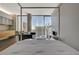 Well-lit bedroom with a four-poster bed, city views, and combined living and kitchen area at 3722 Las Vegas Blvd # 2204, Las Vegas, NV 89158