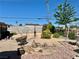 Spacious backyard with gravel landscaping, artistic sculpture, and potential for customization at 4420 Avondale Ave, Las Vegas, NV 89121