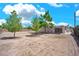 Large backyard with mature trees and a desert landscape, providing ample space for outdoor activities at 45 Prince Ln, Las Vegas, NV 89110