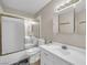 Well-lit bathroom featuring a single sink vanity, a toilet, and a shower/tub with gold trimmed sliding doors at 45 Prince Ln, Las Vegas, NV 89110