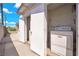 Outdoor laundry area features a washer and dryer, with access from a side yard at 45 Prince Ln, Las Vegas, NV 89110