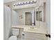 Bathroom features a toilet, vanity, and a shower with a white shower curtain at 4820 Integrity St, North Las Vegas, NV 89031