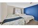 Bright bedroom with two beds, a window, and a blue accent wall at 4820 Integrity St, North Las Vegas, NV 89031