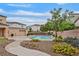 Inviting community pool area with lush landscaping and nearby residential buildings at 4820 Integrity St, North Las Vegas, NV 89031
