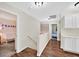 Upstairs hallway with hardwood floors, built-in cabinets, and views into two bedrooms at 4820 Integrity St, North Las Vegas, NV 89031
