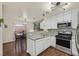 Updated kitchen featuring modern appliances, granite countertops, white cabinets and dining area at 4820 Integrity St, North Las Vegas, NV 89031