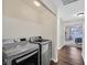 Bright laundry area featuring a modern washer and dryer set and wood-look floors at 4820 Integrity St, North Las Vegas, NV 89031
