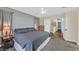 Main bedroom with neutral tones, plush carpet, ceiling fan, and ensuite access at 4820 Integrity St, North Las Vegas, NV 89031