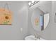 This well-lit powder room features neutral walls, modern fixtures, and sunflower artwork at 4820 Integrity St, North Las Vegas, NV 89031