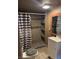 Bathroom features a tiled shower with built-in shelves, a modern vanity, and updated fixtures, blending style and functionality at 4834 E Van Buren Ave, Las Vegas, NV 89110
