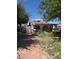 Inviting single-story home with a well-manicured front yard and mature shade trees at 4834 E Van Buren Ave, Las Vegas, NV 89110