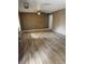 Spacious living room featuring wood-look tile flooring, neutral walls, and a ceiling fan for a comfortable and inviting atmosphere at 4834 E Van Buren Ave, Las Vegas, NV 89110