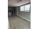 This versatile room has neutral paint, wood-look tile, and natural light from a large window at 4834 E Van Buren Ave, Las Vegas, NV 89110