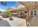 Entertaining backyard features a full outdoor kitchen, bar seating, dining space, and fire pit at 603 Fiddlehead Ave, Las Vegas, NV 89183