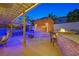 Charming backyard oasis with a tiki hut, built-in bar, and fire pit, perfect for entertaining guests at 603 Fiddlehead Ave, Las Vegas, NV 89183