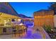Expansive backyard featuring an outdoor bar, fire pit, and tiki hut, creating an ideal space for outdoor living at 603 Fiddlehead Ave, Las Vegas, NV 89183