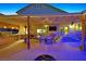 Entertainer's backyard featuring an outdoor kitchen, bar, dining area, spa, and spacious patio at 603 Fiddlehead Ave, Las Vegas, NV 89183