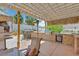 Backyard features a stone-clad outdoor kitchen with a grill, sink, dining bar and shaded seating at 603 Fiddlehead Ave, Las Vegas, NV 89183