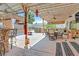 Relaxing backyard featuring a built-in bar, barbecue, shaded seating, and tiki hut-covered spa at 603 Fiddlehead Ave, Las Vegas, NV 89183