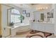 Bright bathroom featuring a glass enclosed shower and soaking tub with dual sink vanity at 603 Fiddlehead Ave, Las Vegas, NV 89183