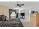 Bedroom features neutral carpet, ceiling fan, stylish black and white decor, and good natural lighting at 603 Fiddlehead Ave, Las Vegas, NV 89183