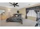 Bedroom features neutral carpet, ceiling fan, stylish black and white decor, and good natural lighting at 603 Fiddlehead Ave, Las Vegas, NV 89183