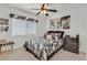 Well-lit bedroom with fan, neutral walls and carpet, with decorative window covering at 603 Fiddlehead Ave, Las Vegas, NV 89183