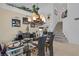 Bright dining room with a contemporary chandelier, set table, and staircase in the background at 603 Fiddlehead Ave, Las Vegas, NV 89183