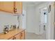 Hallway with wood cabinets for storage and open doorway with neutral paint and carpeting at 603 Fiddlehead Ave, Las Vegas, NV 89183