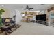 Expansive living room showcases seamless layout with access to the kitchen and backyard with plush carpeting at 603 Fiddlehead Ave, Las Vegas, NV 89183