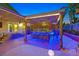 Stylish outdoor bar featuring ample seating, tropical decor, and ambient lighting for a relaxed atmosphere at 603 Fiddlehead Ave, Las Vegas, NV 89183