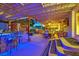 Inviting outdoor patio featuring a covered seating area, bar with lighting, and dining space at 603 Fiddlehead Ave, Las Vegas, NV 89183