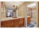 Bathroom with a large vanity with double sinks, tile countertops, a bathtub and walk-in shower at 611 Spyglass Ln, Las Vegas, NV 89107