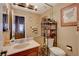 Well-lit bathroom with a single sink, mirror, and storage shelves at 611 Spyglass Ln, Las Vegas, NV 89107