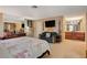 Bedroom featuring a large bed, TV, vanity and an ensuite bath for convenience and comfort at 611 Spyglass Ln, Las Vegas, NV 89107
