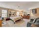 Spacious bedroom with a cozy sitting area, large bed, and ample natural light from the windows at 611 Spyglass Ln, Las Vegas, NV 89107