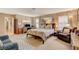 Bright bedroom featuring a queen-size bed, cozy seating, and abundant natural light, perfect for relaxation at 611 Spyglass Ln, Las Vegas, NV 89107