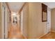 Hallway featuring hardwood floors, textured walls, and decorative mirror, exuding classic charm at 611 Spyglass Ln, Las Vegas, NV 89107