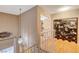 Hallway with decorative accents and wood floors, leading to a bedroom or office space at 611 Spyglass Ln, Las Vegas, NV 89107