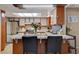 Well-lit kitchen with stainless steel appliances, tile countertops, and an inviting breakfast bar at 611 Spyglass Ln, Las Vegas, NV 89107