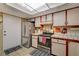 A functional kitchen features white cabinets, tile countertops, and essential appliances at 611 Spyglass Ln, Las Vegas, NV 89107