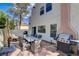 Cozy patio with grill, outdoor table, and chairs, ideal for relaxing and entertaining friends at 611 Spyglass Ln, Las Vegas, NV 89107