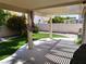 Covered back patio area looking out to the green lawn at 6508 Alpine Forest Ct, Las Vegas, NV 89149